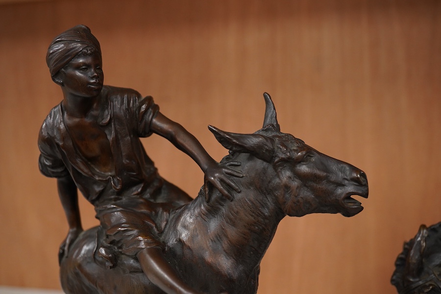 After Paul Aichele (1859-1910), a pair of bronze figures of Arab boys riding donkeys, 23cm